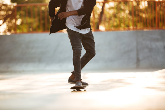 Cropped image of an african skateboarder skating