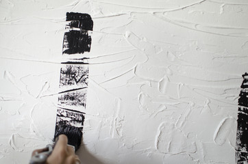 Black and white textured background. Black paint on the white free designed wall