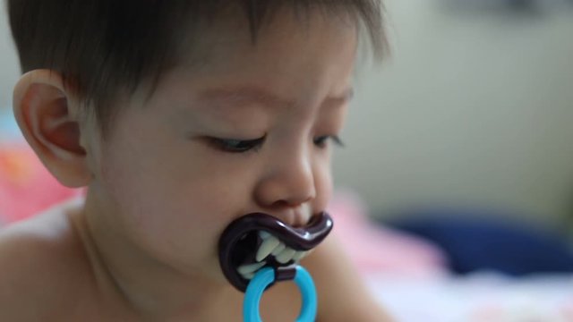asian baby kid sucking nipple pacifier fancy vampire teeth dracula devil in halloween celebration party
