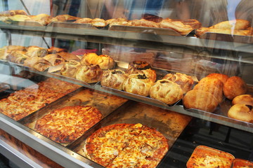 Traditional savoury pastry with filling. Fresh pastizzi and snacks for sale in a pastizzeria. Malta