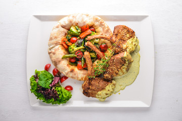 Veal steak on the bone. Grilled vegetables. Top view. Free space for text. On a wooden background.