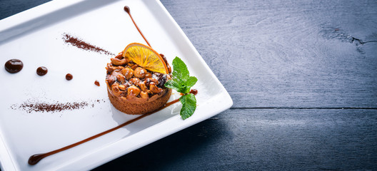 Nut Milk Chocolate Dessert. Top view. Free space for text. On a wooden background.