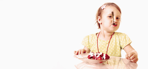 A little beautiful baby girl eating and enjoying of fresh strawberries. (Health, Nutrition, Vitamins, Happy Childhood Concept)