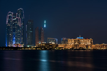 Fototapeta na wymiar Abu Dhabi buildings skyline from the sea at night