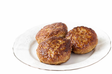 Homemade cutlets  on a white plate and white background.