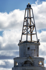 Fototapeta na wymiar Lighthouse close up in a cloudy sky