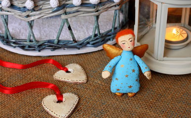 Beautiful little angel and hearts. Traditional New Year's toys. Christmas holidays. Textile handmade doll.