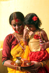 Traditional bengali woman with her daughter playing Sindur on the last day of Durga Puja, Calcutta...
