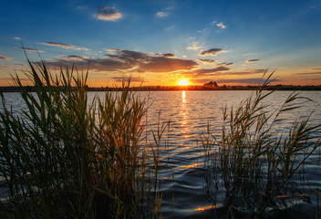 Summer landscape. Sunset over water.