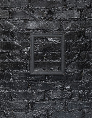black elegant frame on a black brick wall
