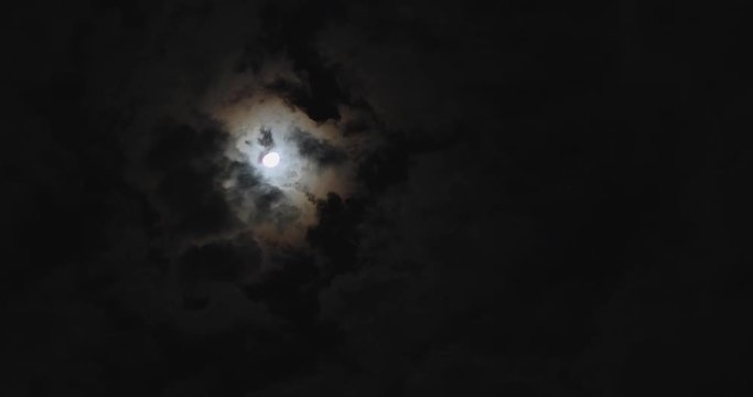 time-lapse, dark night dramatic sky with moon light and moving clouds