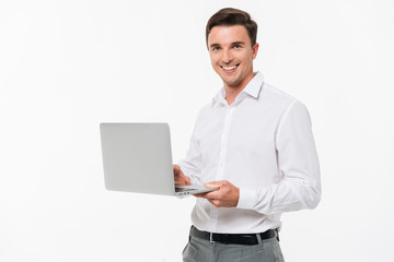 Portrait of a happy young man holding laptop computer