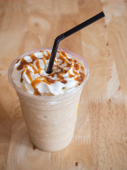 Coffee caramel frappe with whipped cream in a coffee shop