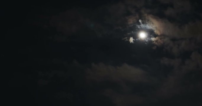 time-lapse, dark night dramatic sky with moon light and moving clouds