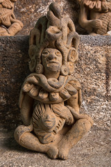 closeup of antique statue in a Maya ritual praying room