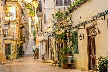 Fototapeta na wymiar Nafplio-one of the narrow cobblestone alleys with the neoclassical well preserved buildings of the old town.