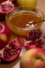 Pieces ripe pomegranate, honey and apple