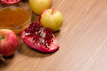 Pieces ripe pomegranate, honey and apple