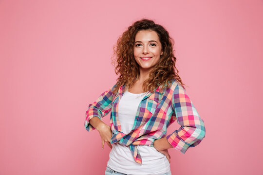 Portrait of happy woman posing isolated over pink