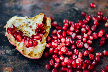 Healthy food background - pomegranate fruit and seeds.