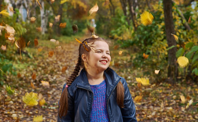 little girl having fun on beautiful autumn