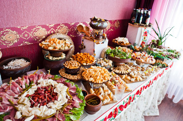 Cheese and meat decorated dishes on the wedding banquet.