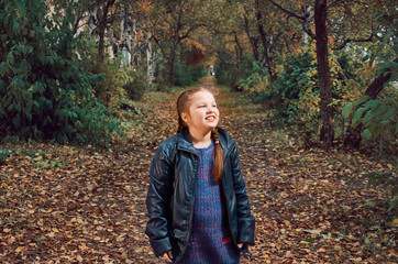 little girl having fun on beautiful autumn