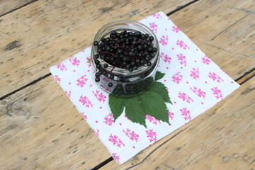 Fototapeta na wymiar Elderberry fruits in glass jar