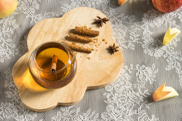 hot apple juice in glass with cinnamon. autumn food concept