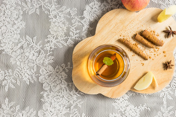 top view hot apple juice in glass with cinnamon. autumn food concept