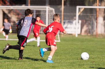 Kids soccer football - children players match on soccer field