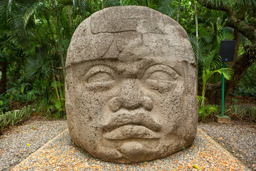 large pre-hispanic olmec basalt carved head in the La Venta archeological park in Villahermosa Mexico