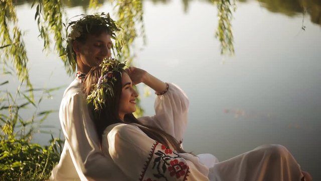 a romantic date on the riverbank. man and woman in the Slavic suit