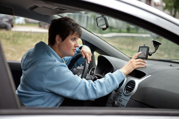 Female Driver Looking for the Way with Navigator