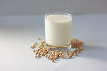 Soy milk with soy beans around it.