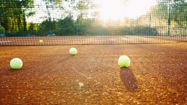 Tennis ball rolling along tennis court