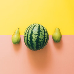 watermelon and two pears on yellow and pink background