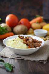Soy meat with potato puree over kitchen table.
