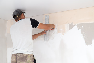 the worker plastered the mortar on the wall