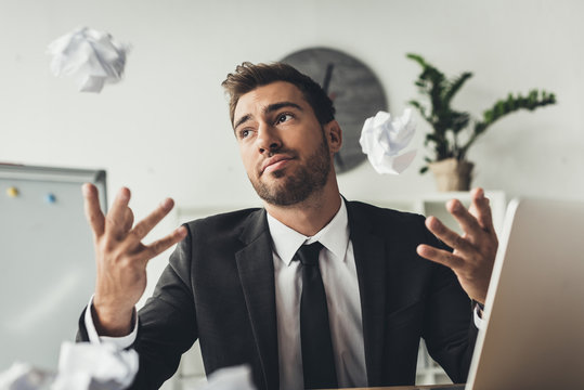 Businessman Throwing Crumpled Papers