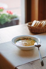 Nice and hot soup at the white ceramic plate at the restaurant.