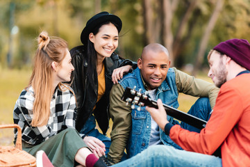 multicultural friends resting in park