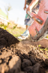 Fototapeta premium a woman digs a garden with a shovel