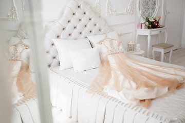 Wedding Dress. The bride's dress rests on the bed