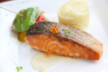 Baked salmon , salmon steak with potatoes on white wine sauce