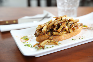 Crispy toasted white bread with mushrooms on wood background table