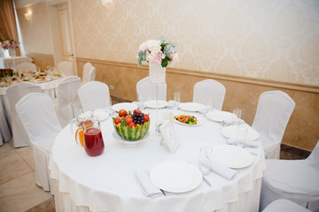 Table decorated for a wedding ceremony with carved fruits flowers
