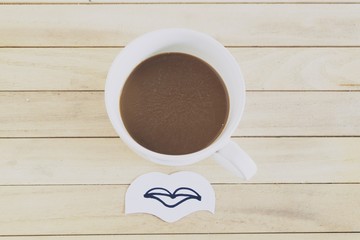 White coffee cup in high angle and mount picture in paper