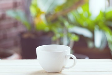 White coffee cup on wooden floor