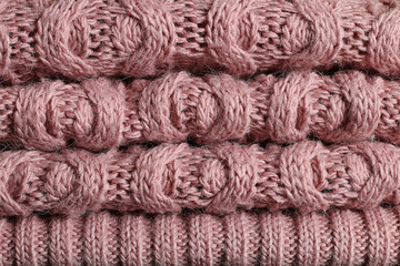 A pile of women's winter pink sweaters